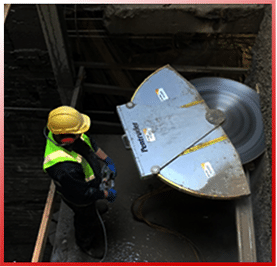 Diamond blade cutting through a concrete wall