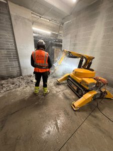 Operator controlling Brokk remote demolition during internal concrete break-out